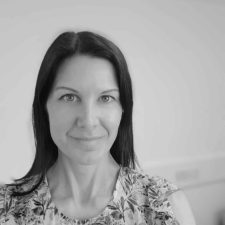 Photo of Charlotte Davies, Managing Director of Common Seas. Image in greyscale. Charlotte wears a floral blouse and faces the camera.