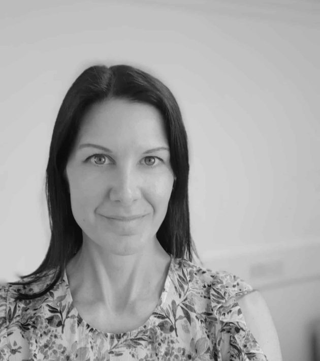 Photo of Charlotte Davies, Managing Director of Common Seas. Image in greyscale. Charlotte wears a floral blouse and faces the camera.