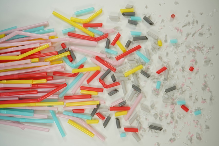 Multi-coloured straws in a bunch, chopped up and in microplastic particles