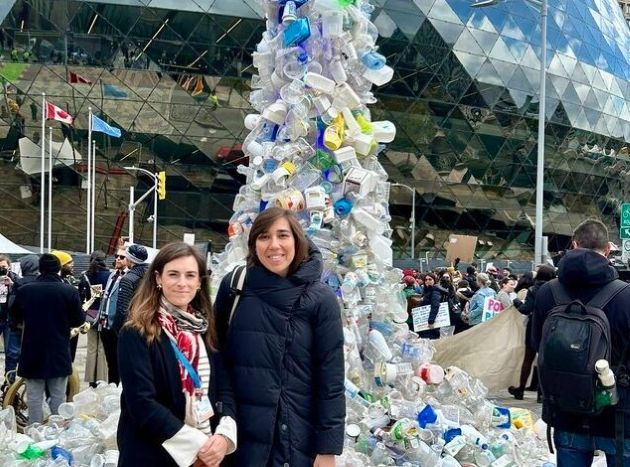 Two women standing in front of a torrent of plastic pollution - at artwork at the fourth round of treaty negotiations towards a global plastics treaty