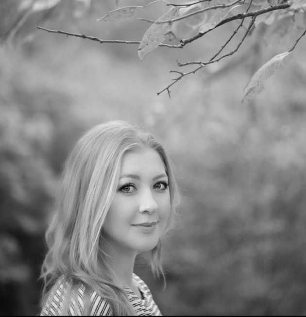 Profile photo of Emma Kai Thomas, Senior Communications Manager at Common Seas. Emma wears a striped jumper and smiles at the camera side-on. Photo is in greyscale.