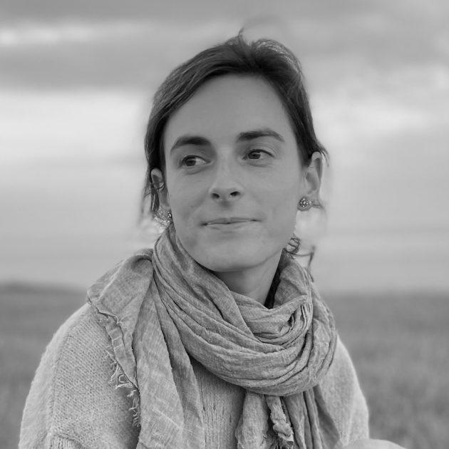 Profile photo of Carla Worth, Head of Policy at Common Seas. Carla wears a knitted top and scarf, and smiles looking to the left of the frame. Photo is in greyscale.